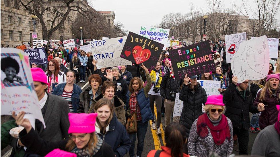 Women holding protest signs for women's rights