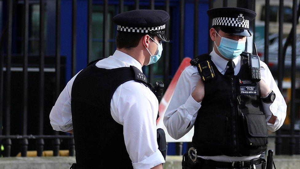 Police officers wearing face masks