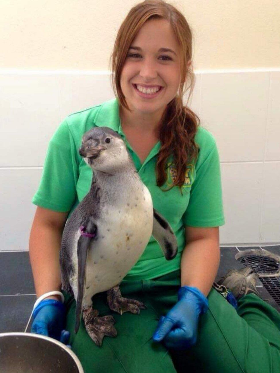 zoo keeper with penguin