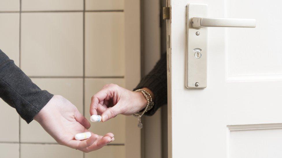 Tampon being passed to someone in the toilet