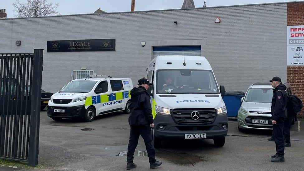 Police vehicles outside funeral directors home