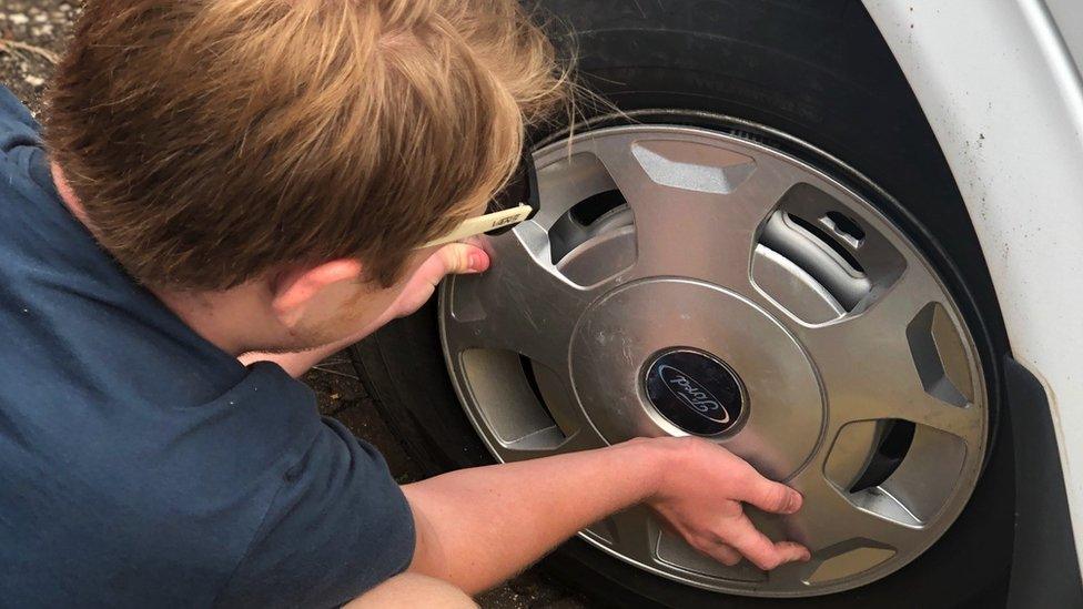 Matthew fitting a hubcap