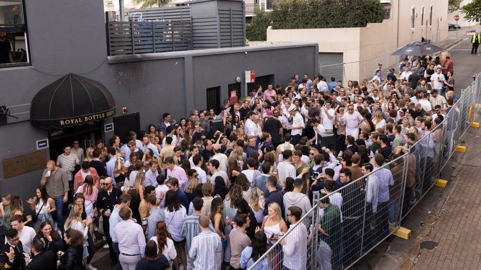 Sydneysiders outside a pub in April, celebrating the Anzac Day holiday