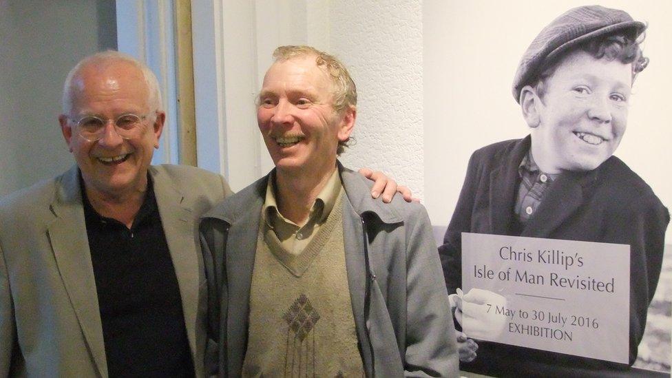 Chris Killip and Keith Callister standing in front of a photo of Keith as a boy