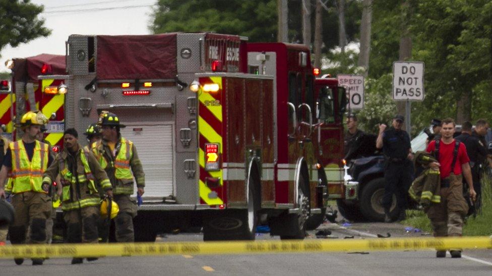 Police and rescue workers attend to the scene after multiple bicyclists were struck by a vehicle in a deadly crash Tuesday, June 7, 2016, in Copper Township, Michigan