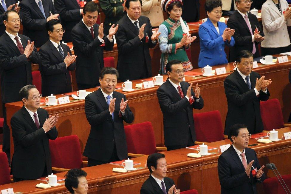 China's President Xi Jinping (2nd row, 2nd L), Premier Li Keqiang (2nd row, 2nd R), Politburo Standing Committee member Liu Yunshan (2nd row, R) and Chairman of the National Committee of the Chinese People's Political Consultative Conference (CPPCC) Yu Zhengsheng (2nd row, L) clap during the closing ceremony of National People's Congress (NPC) at the Great Hall of the People in Beijing, China, 16 March 2016.