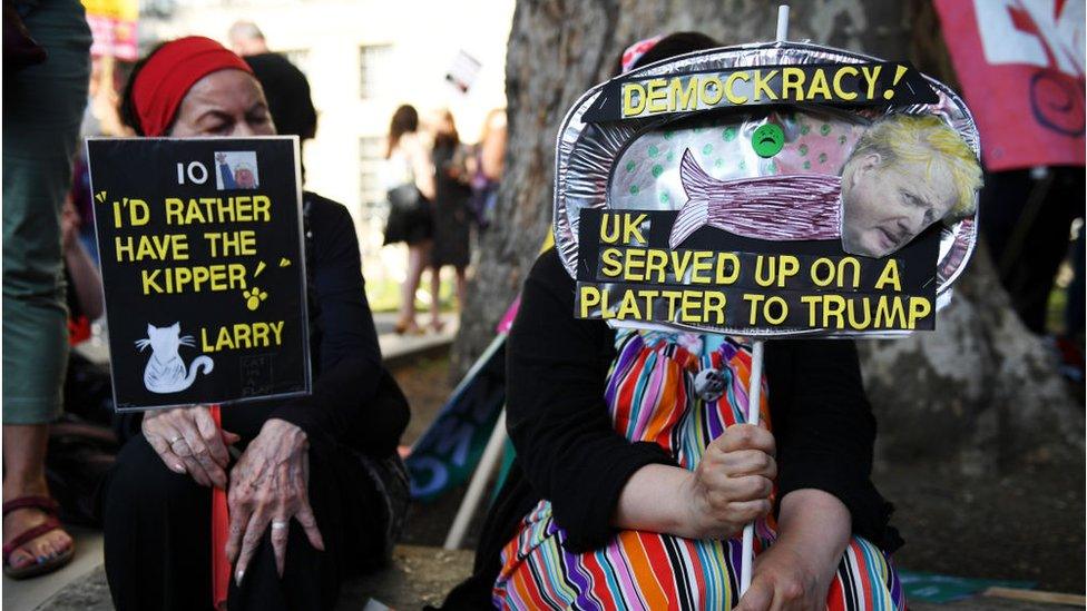 People take part in a protest against Boris Johnson organised by the People's Assembly near Downing Street