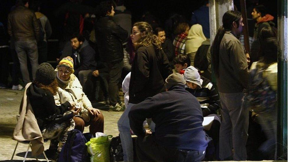 People remain in the street after a tsunami alert in Valparaiso, Chile on 16 September, 2015.