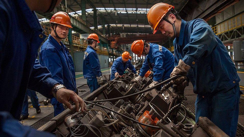 Workers maintain the production line at the Zhong Tian (Zenith) Steel Group Corporation in Changzhou, Jiangsu, China