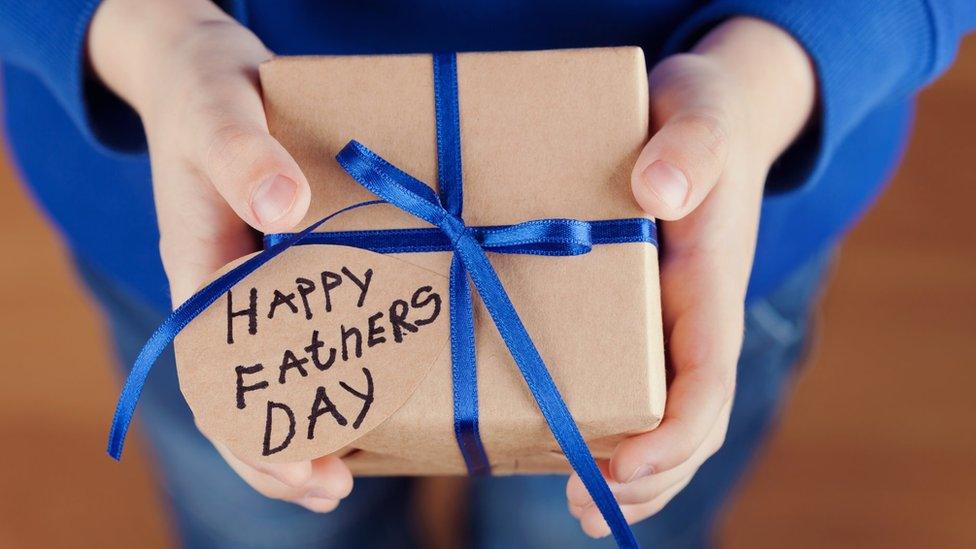 A child holding a father's day present