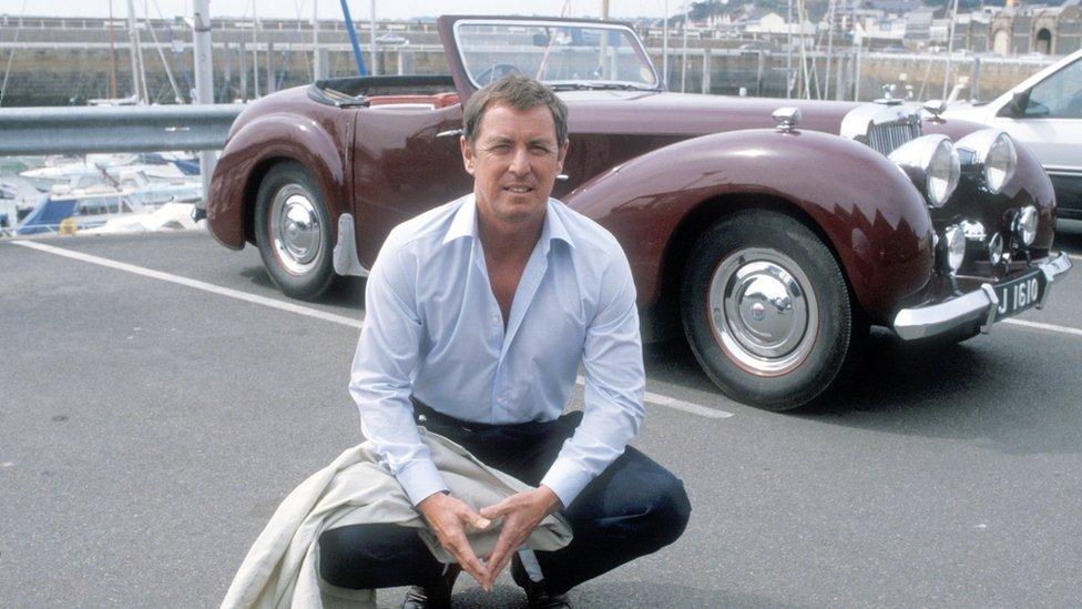 Bergerac is pictured in front of his burgundy Triumph 1800 roadster car