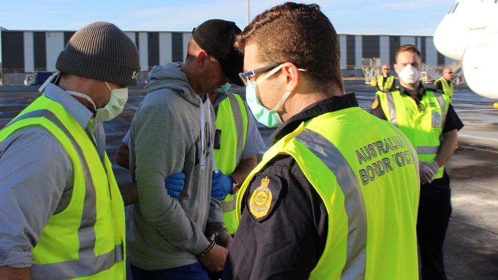 Christopher Clark Jones surrounded by officers