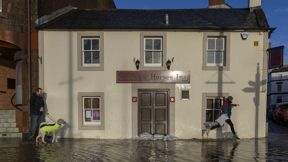 Flooded roads in Whitesands, Dumfries. An amber weather warning of heavy rain has been issued for part of Scotland as the Met Office said the deadly bomb cyclone that sent temperatures plunging in the US is now causing wet and windy weather in the UK.