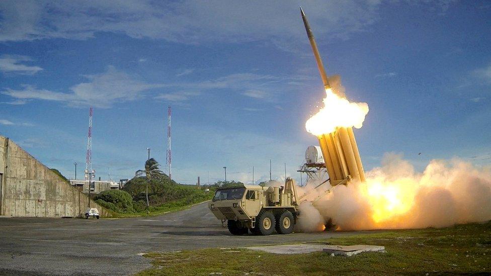 A Thaad launcher, resembling a truck with many large upward- pointing launch tubes, fires an interceptor missile on a testing range in an undated handout photo