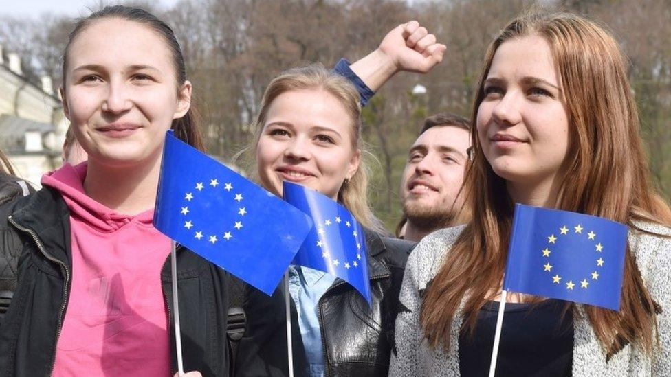 Ukrainian students hold EU flags during a rally on European Square in Kiev (06 April 2016)