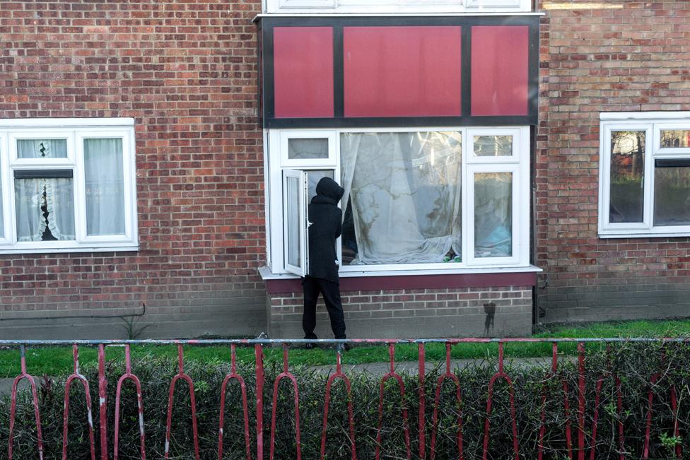 Hooded person outside window in Ipswich