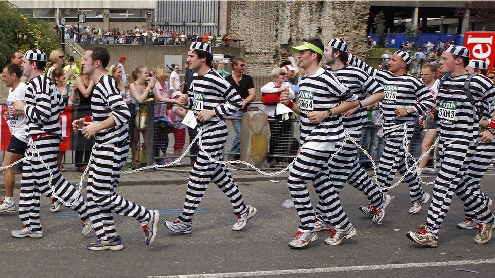 Runners dressed as prisoners and chained together pass the Tower of London as they enter the final three miles of the London Marathon in 2007