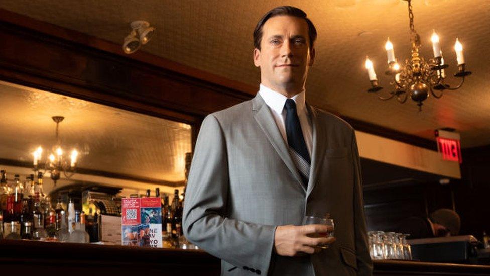 Madame Tussauds Jon Hamm wax figure holds a glass of whisky