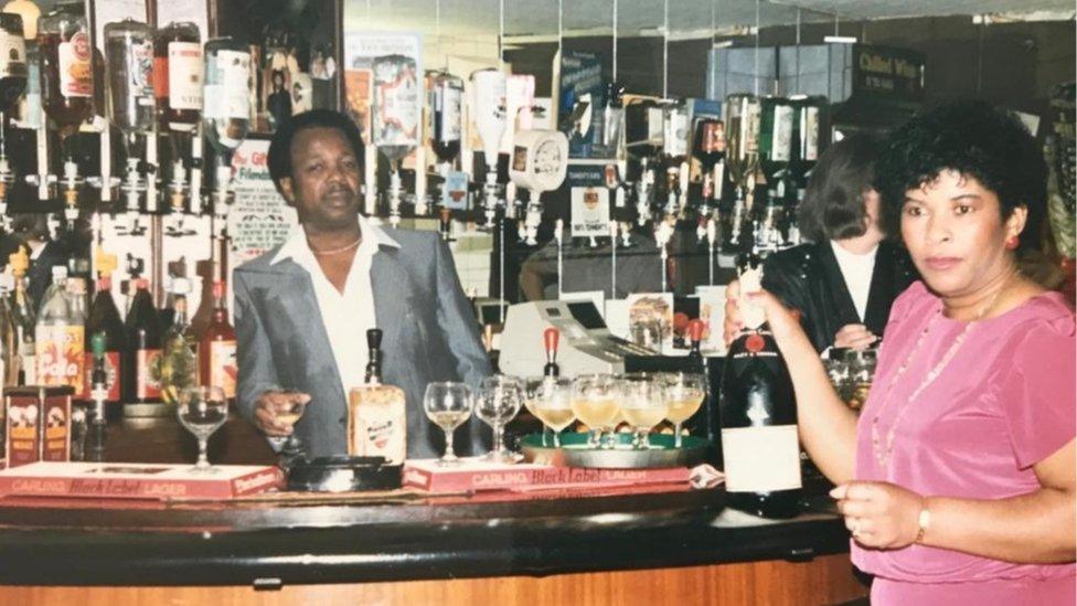 Mr Campbell behind the bar of the Iron Master pub with his wife