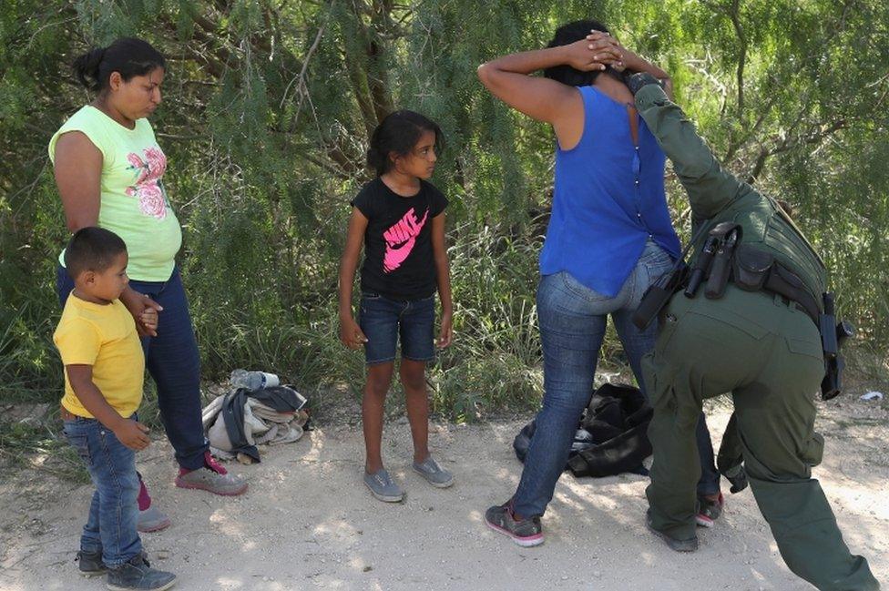 Central American asylum seekers are taken into custody by US Border Patrol agents on 12 June 2018 near McAllen, Texas.