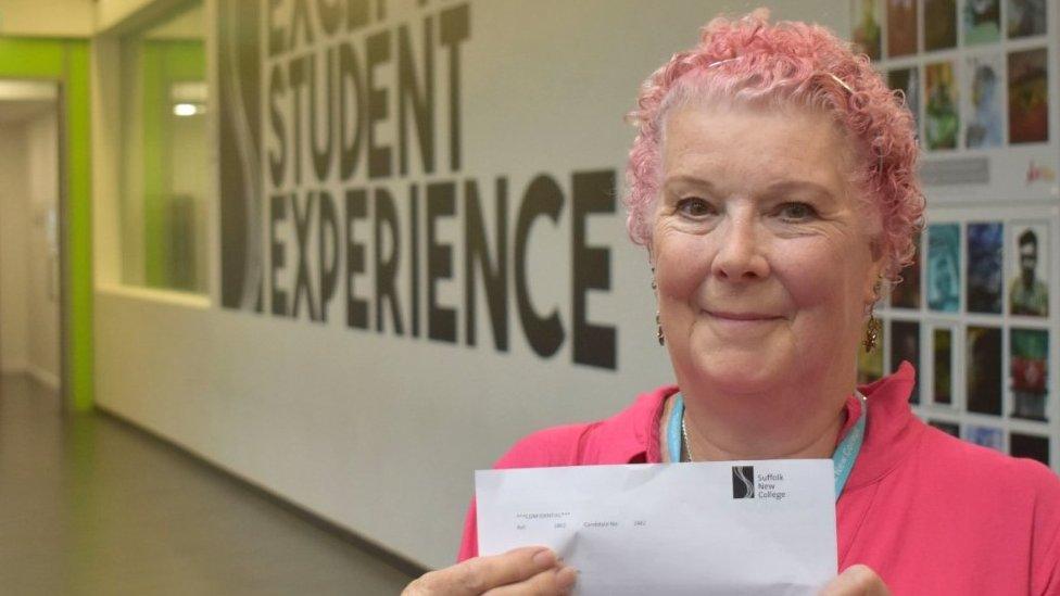 Anne Blowers holds up GCSE certificate