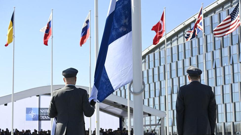 Finnish military personnel install the Finnish national flag at the NATO headquarters in Brussels, on April 4, 2023