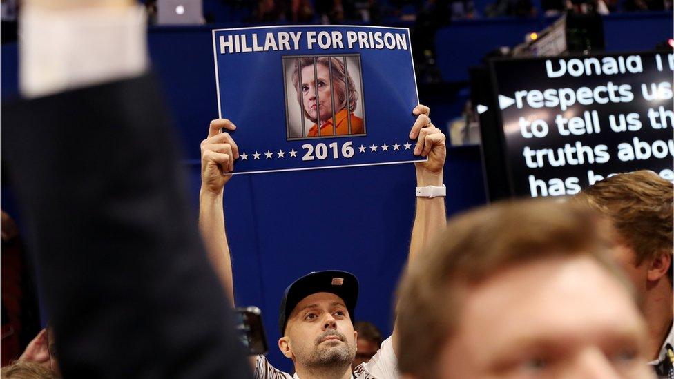 A delegate holds up a sign that reads "Hillary For Prison" on the third day of the Republican National Convention