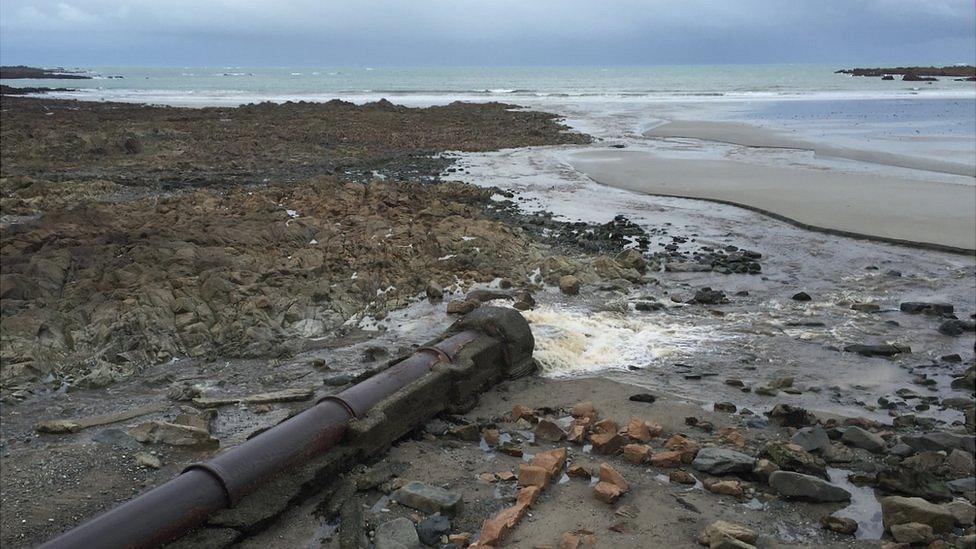 Sewage pouring onto the beach at Vazon, Guernsey