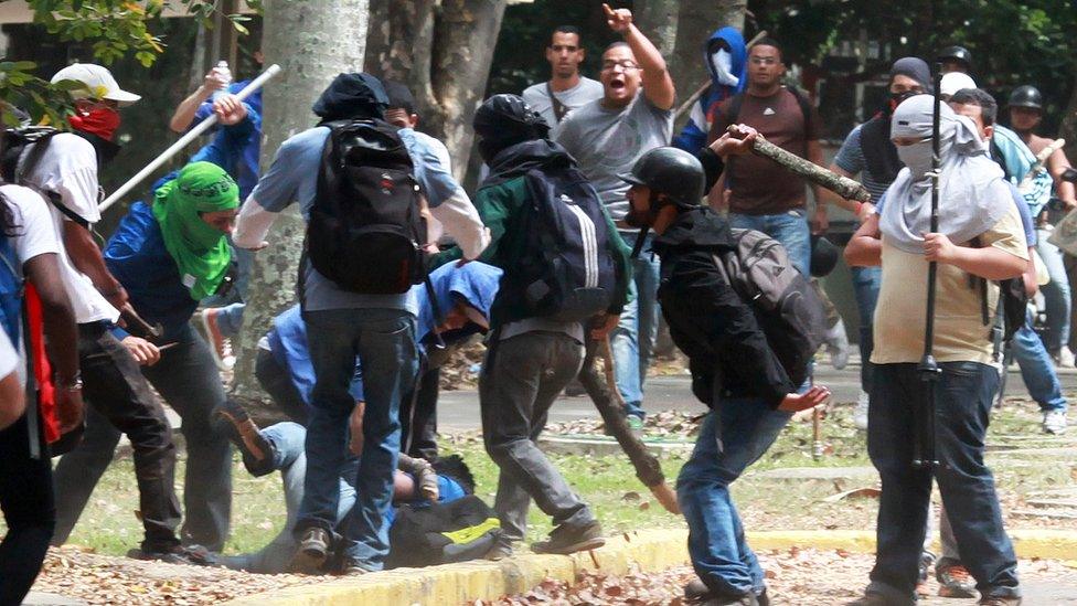 Members of a 'colectivo' pro government group beat an opposition student who was taking part in a protest in Caracas on 3 April 2014