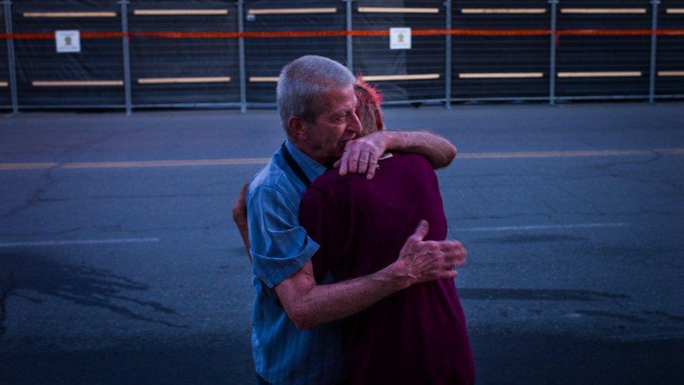 Marcel Larrivee (L) comforts Patricia Landry after the pair first witnessed the aftermath of the destruction