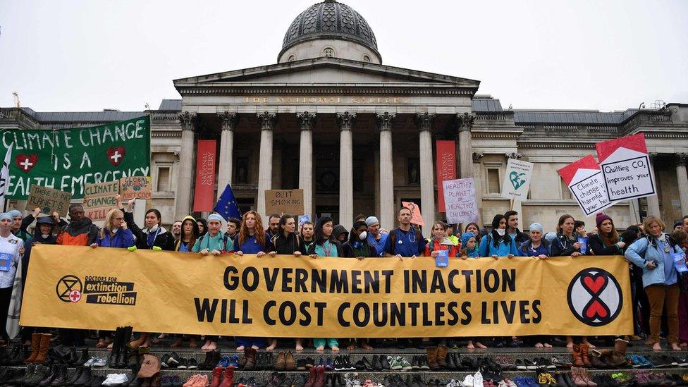 Protesters alongside shoes on Trafalgar Square steps