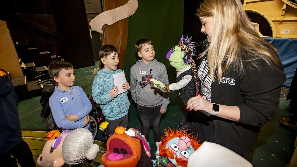 Children talking to puppets