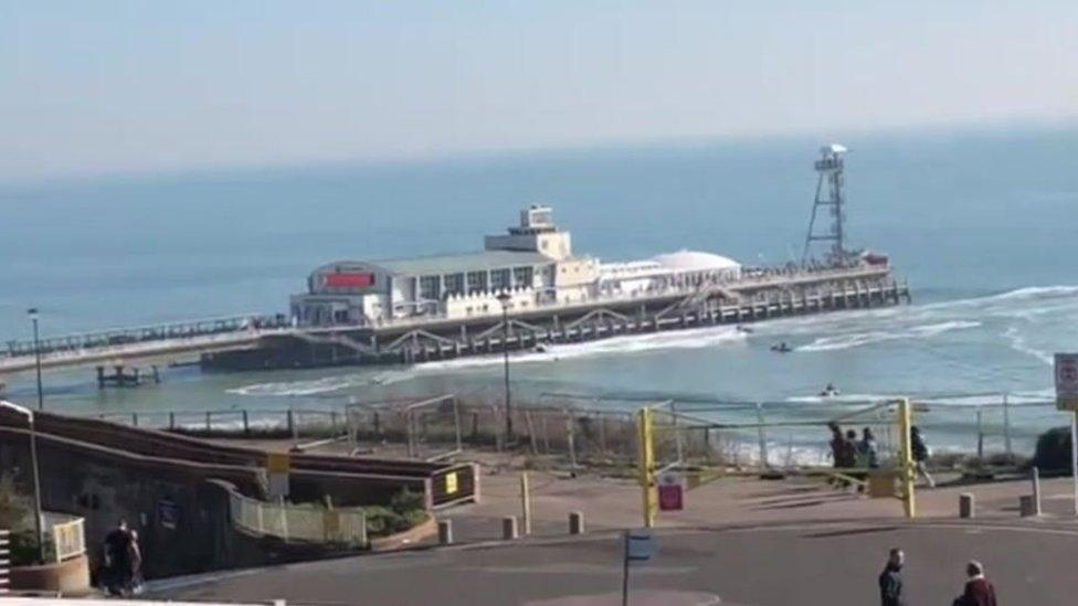 Jetskis near surfers at Bournemouth