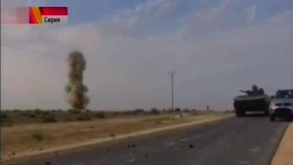 Screengrab from Russian Channel One TV showing a tank firing in Syria