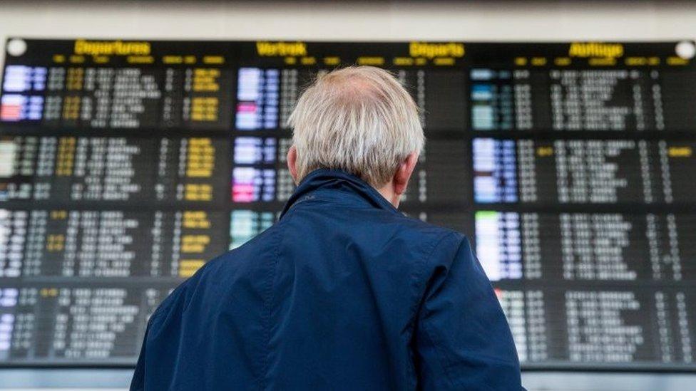 A man stands in front of the departure board at Brussels Airport in Zaventem, Belgium (23 August 2017)