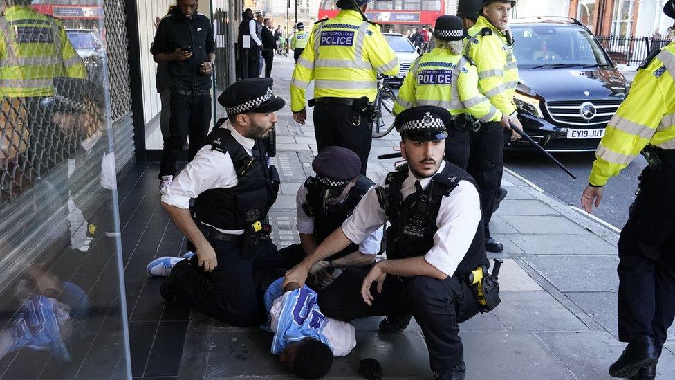 Man being held by police