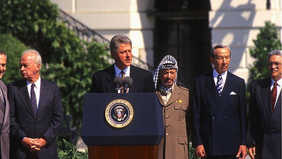 Israel Prime Minister Yitzhak Rabin, US President William Clinton, Palestine Liberation Organization leader Yasser Arafat, US Secretary of State Warren Christopher, and Palestine Liberation Organization negotiator Mahmoud Abbas on the White House lawn for the signing of the Oslo accords in September 1993