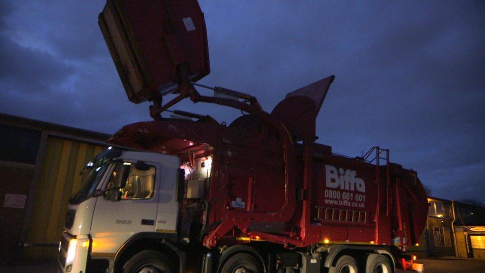 Biffa truck lift prepares to tip contents of recycling container into its compactor