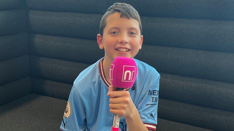 Finley holding a Newsround microphone