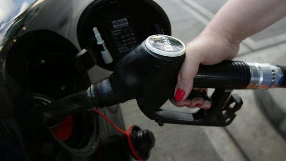 Woman filling up her car