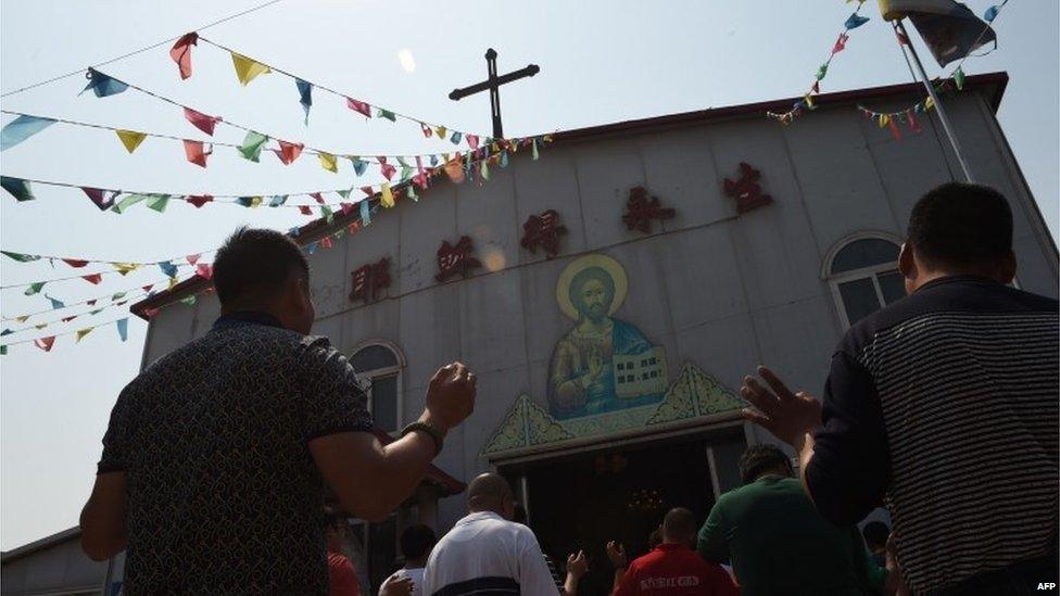 This photo taken on May 24, 2015 shows worshippers celebrating the Feast of the Ascension at the "underground" Zhongxin Bridge Catholic Church in Tianjin. Tianjin,