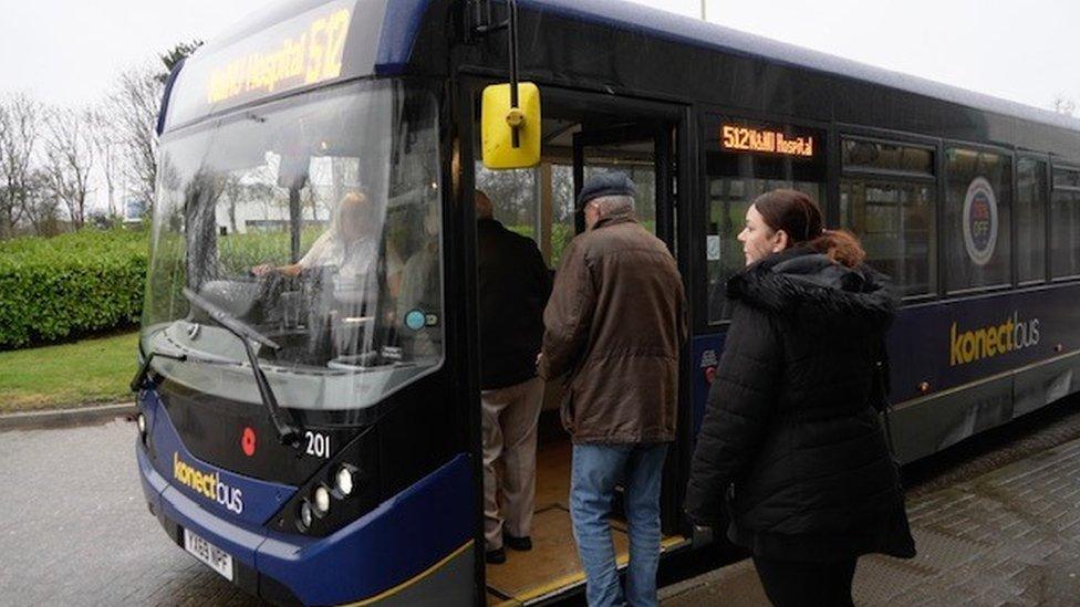 Passengers board a bus