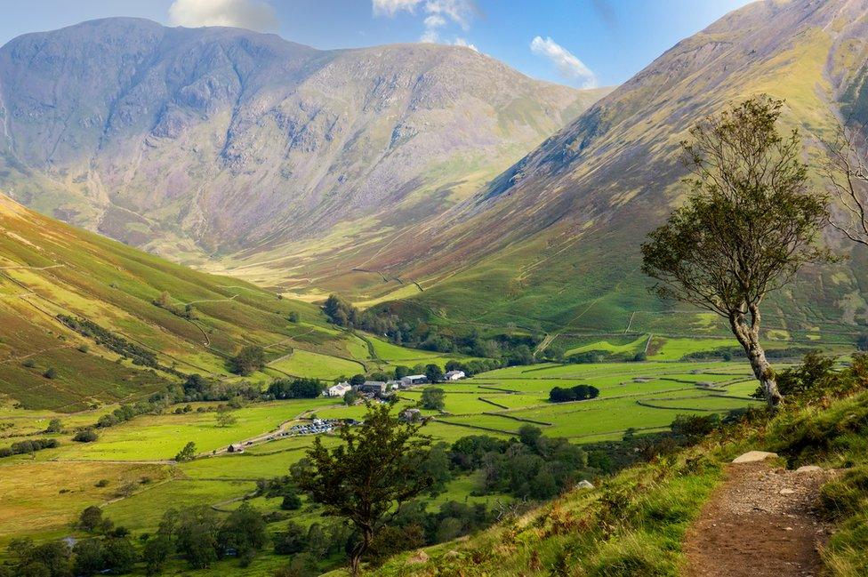 View of a valley surrounded by large hills