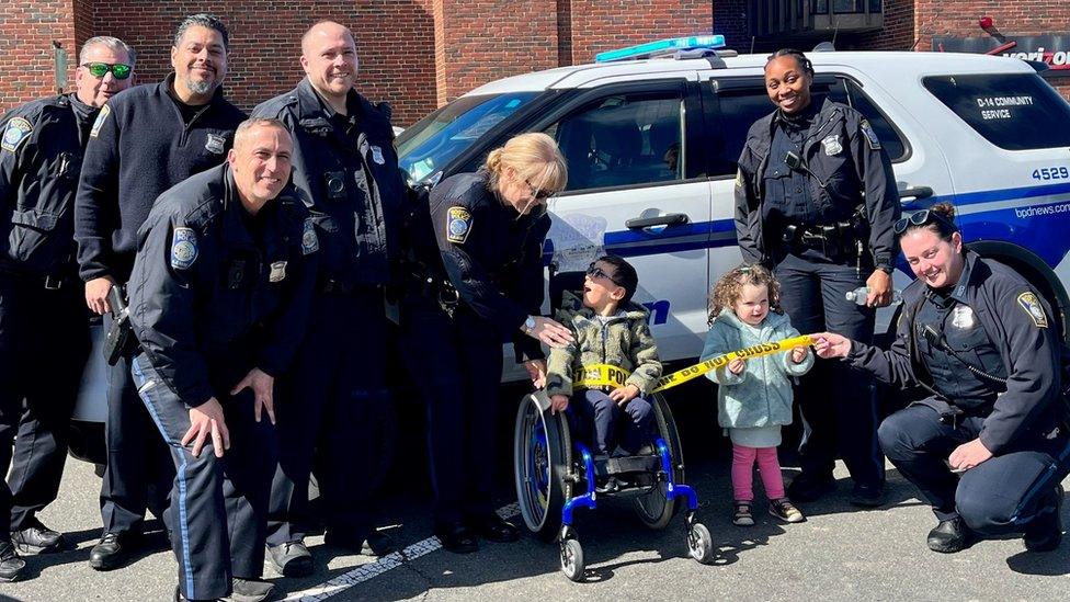 Oisín and his sister, Naoise posing with officers