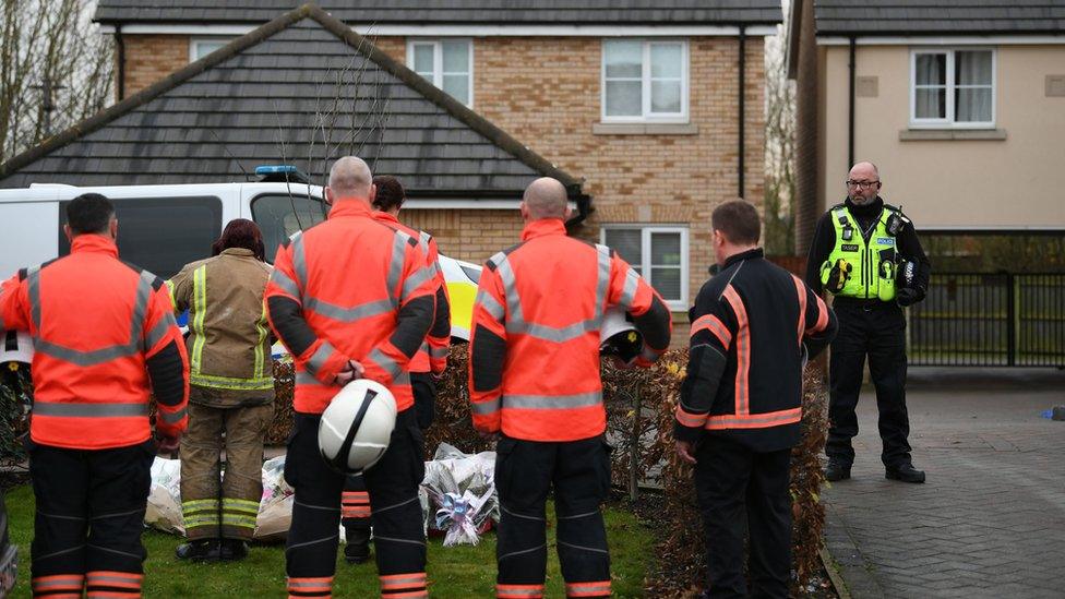 Members of Cambridgeshire Fire and Rescue Service laid flowers at the scene