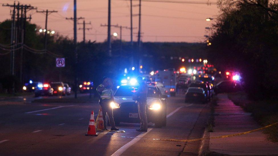 Police officers investigate an incident they say involved an incendiary device in Austin, Texas, 20 March 2018