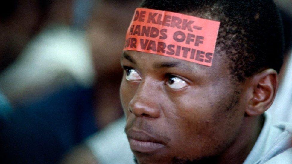 A student with the sticker on his forehead saying "De Klerk, hands off our Varsities", protest against the law of Education Minister Frederik de Klerk which prohibits all forms of anti-apartheid contestation on university campuses in 1987