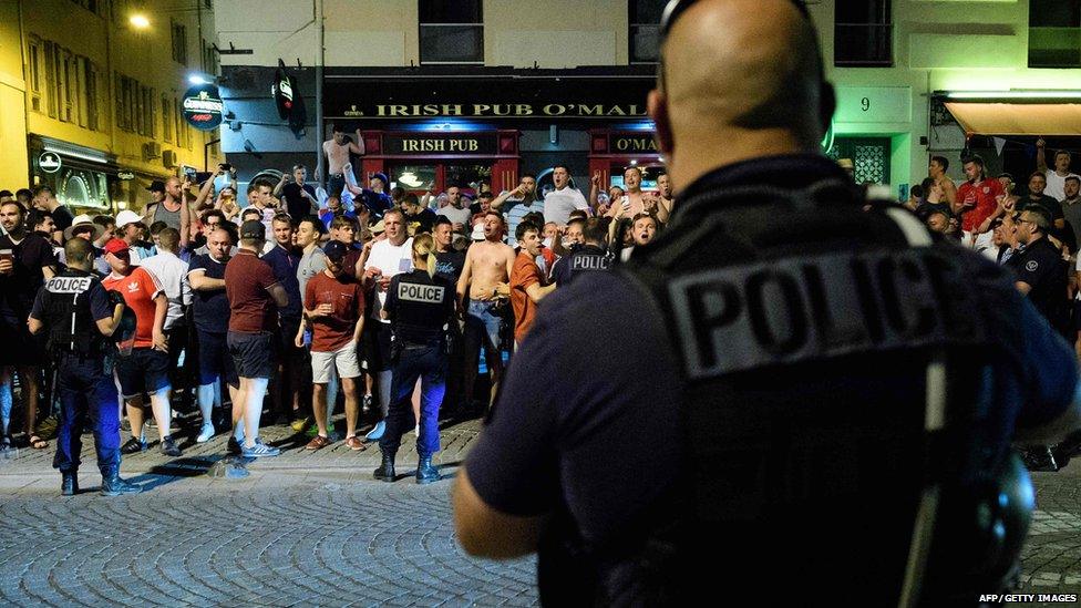 Police stand in front of England fans