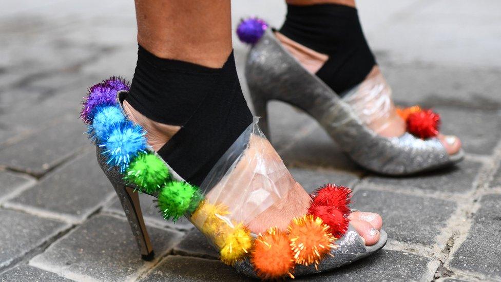 Feet-in-high-heels-with-tape-and-pom-poms.