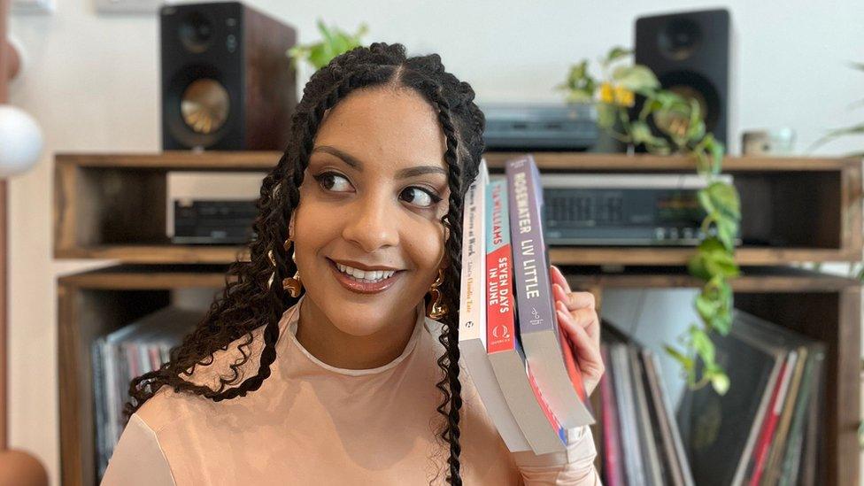 Sofia posing with some books